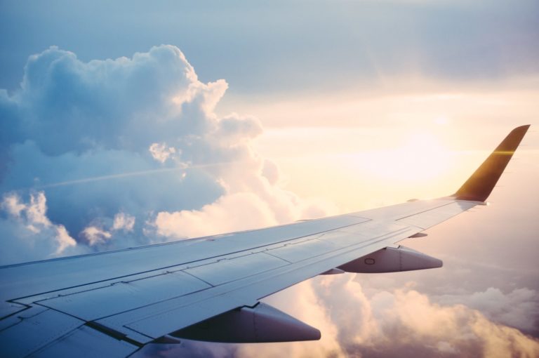 Airplane flying over a scenic landscape